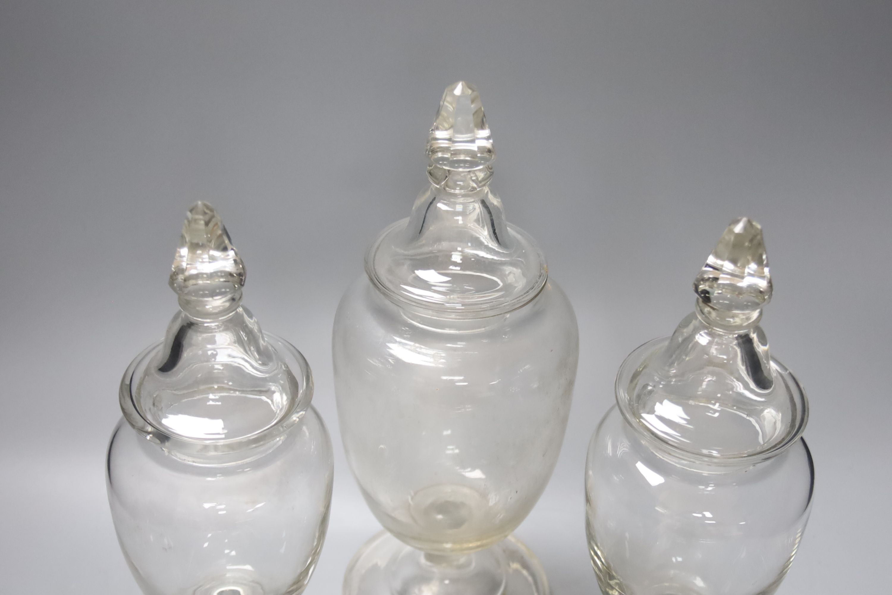 A garniture of three Victorian glass sweet jars, tallest 34cm